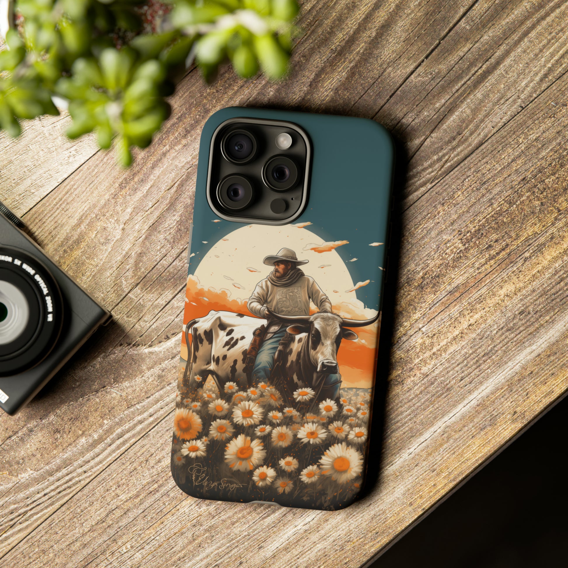 Harmony of Contrasts: Dive into our Tough Cell Phone Case, a visual symphony featuring a bullrider on a black and white dairy cow amidst a vibrant field of flowers. This edition effortlessly merges toughness with artistic flair, offering a unique and captivating contrast. Elevate your phone with rugged elegance. #ElizaSinger #PhoneCase #ContrastHarmony