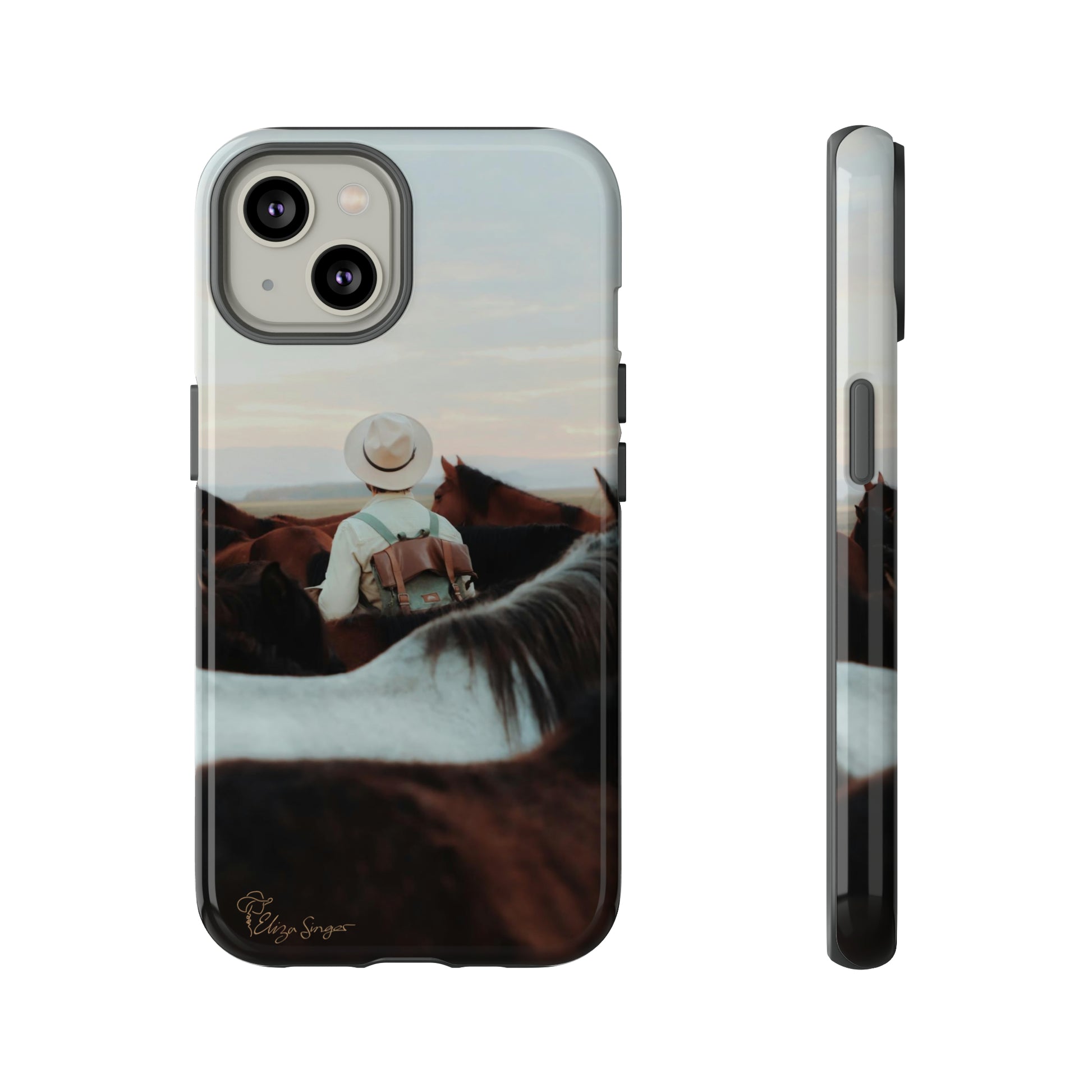 Ride into the Wild: Horse Art Western Photo Yellowstone Design iPhone Tough Protective Cover. Featuring a Cowboy amidst Mountains and Buckskin hues. Compatible with iPhone 15, 14, 13, XS, XR Pro/Max/Mini/P/Plus. Embrace the Spirit of the West with Style and Durability. #ElizaSinger #PhoneCase #WesternDesign