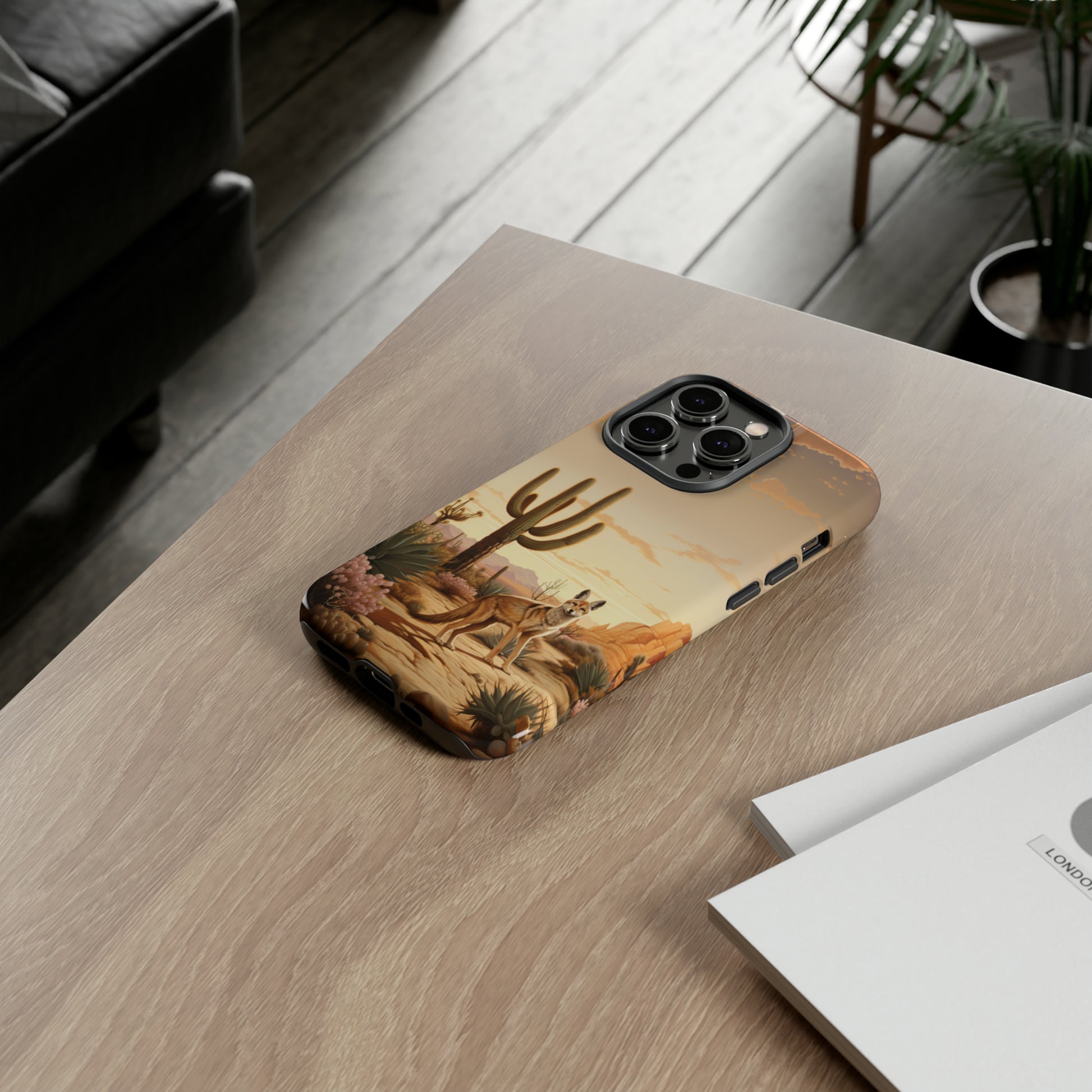 Unveiling our Western Tough Cell Phone Case: Dusk Jackal Oasis Edition! Witness the beauty of dusk with a jackal in a desert landscape next to a cactus. This design offers both rugged protection and a touch of twilight elegance.