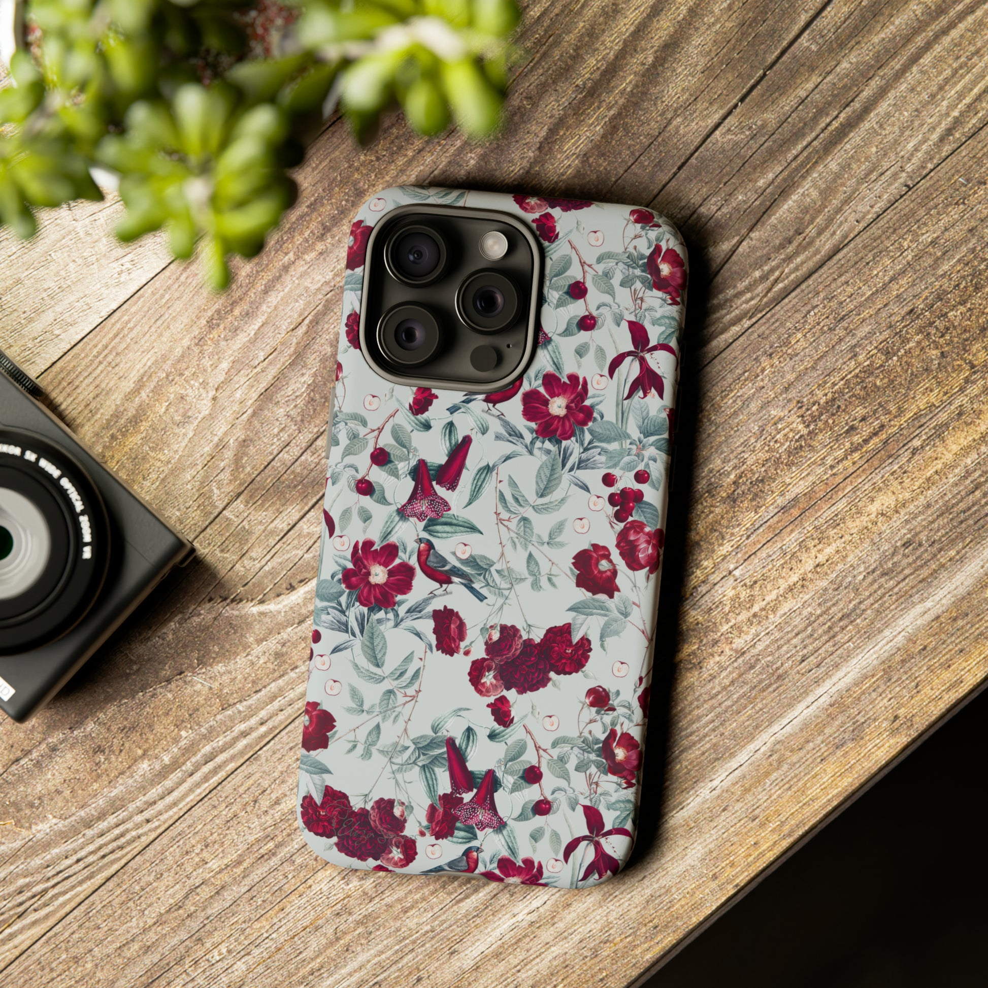 Cherry Blossom Serenade: Cherish nature's beauty with 'Cherry Blossom Serenade.' This iPhone case features flowers and burgundy birds on a blue background, creating a captivating floral wildlife bird and flower design. Elevate your device with this enchanting and stylish protective cover. #ElizaSinger #PhoneCase #FloralDesign