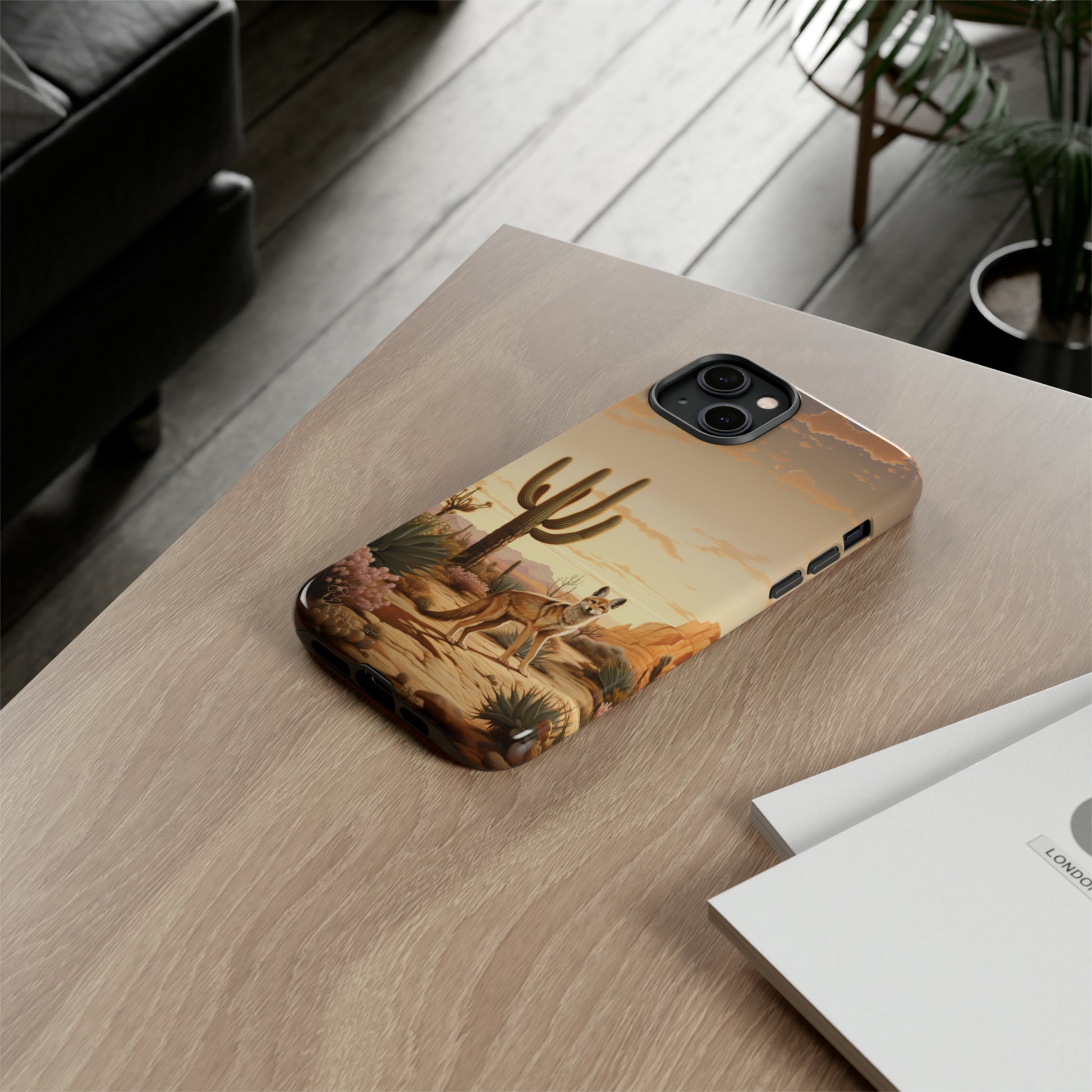 Unveiling our Western Tough Cell Phone Case: Dusk Jackal Oasis Edition! Witness the beauty of dusk with a jackal in a desert landscape next to a cactus. This design offers both rugged protection and a touch of twilight elegance.
