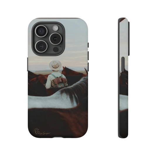 Ride into the Wild: Horse Art Western Photo Yellowstone Design iPhone Tough Protective Cover. Featuring a Cowboy amidst Mountains and Buckskin hues. Compatible with iPhone 15, 14, 13, XS, XR Pro/Max/Mini/P/Plus. Embrace the Spirit of the West with Style and Durability. #ElizaSinger #PhoneCase #WesternDesign