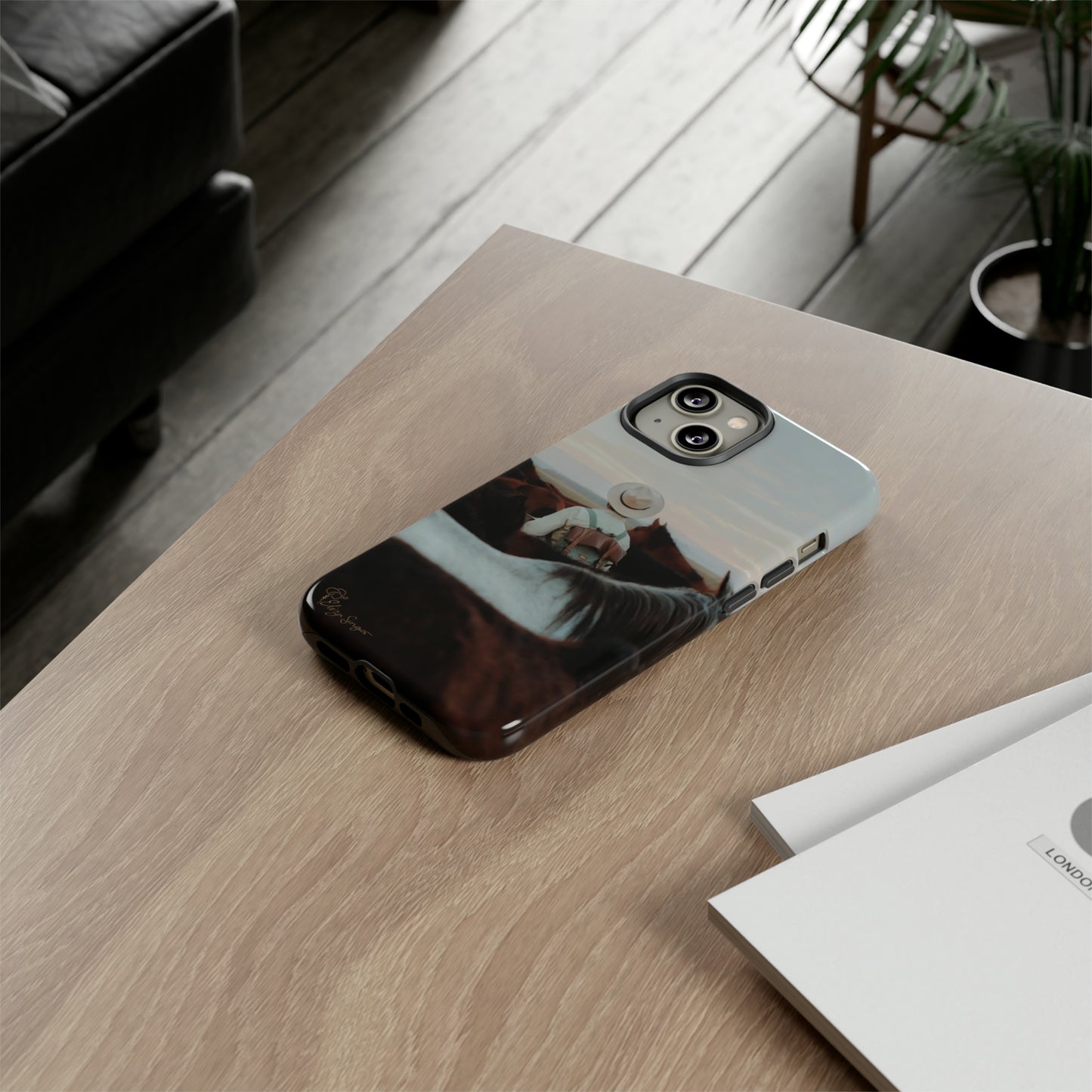 Ride into the Wild: Horse Art Western Photo Yellowstone Design iPhone Tough Protective Cover. Featuring a Cowboy amidst Mountains and Buckskin hues. Compatible with iPhone 15, 14, 13, XS, XR Pro/Max/Mini/P/Plus. Embrace the Spirit of the West with Style and Durability. #ElizaSinger #PhoneCase #WesternDesign