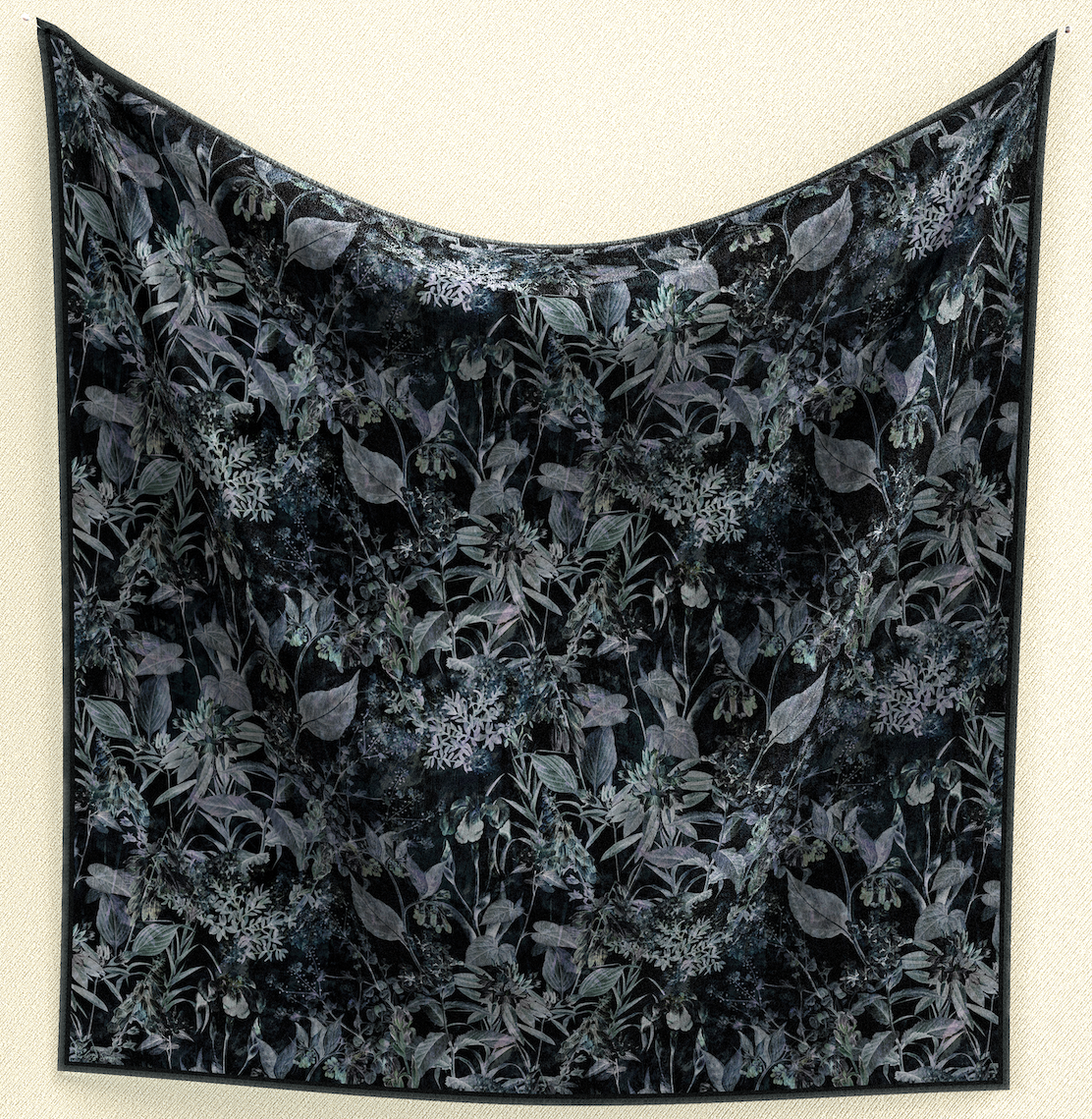 Embrace mystery with Moody Garden Shadows Wild Rag. Against a black background, muted botanical prints create a captivating 35" square of poly/mulberry silk. Elevate your wardrobe with this unique and enigmatic accessory.