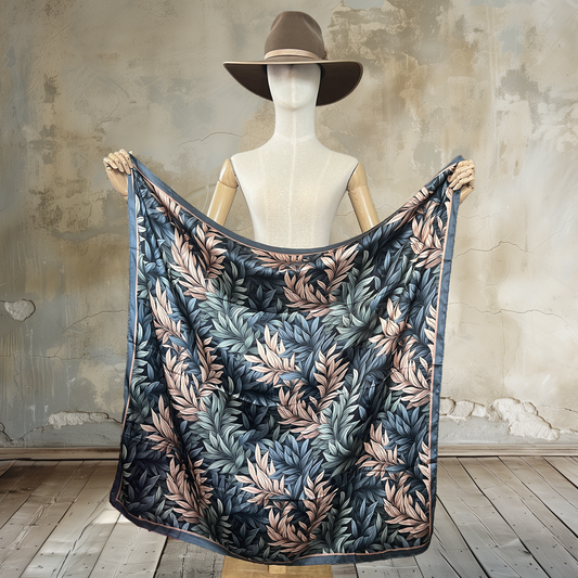 Find tranquility with our Whispering Leaves Wild Rag. Shades of grey/blue, wheat, and green form delicate leaf patterns on this 39" square of

100% satin silk. Elevate your style with this subtle and nature-inspired accessory.